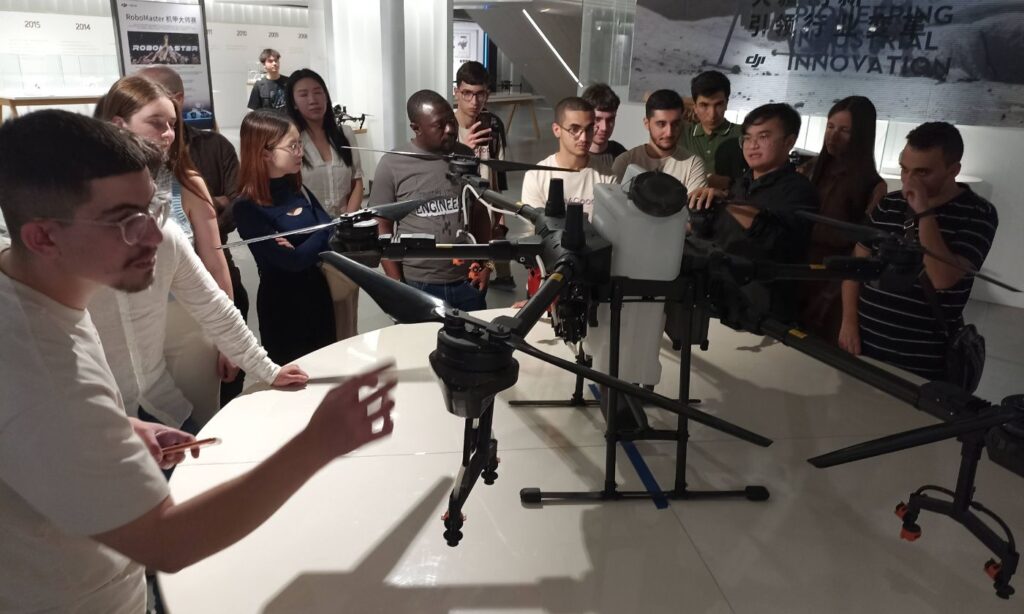 Drone on table surrounded by people